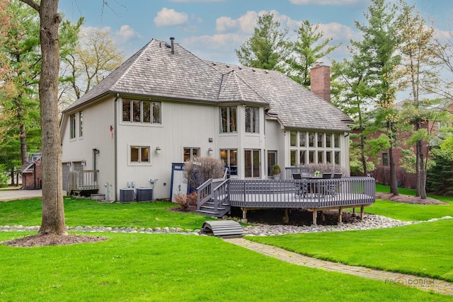 318 Camelot Ln, Libertyville, IL 60048 - back of property featuring a chimney, a deck, a yard, and central AC