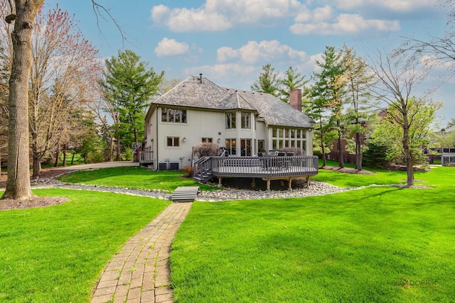 318 Camelot Ln, Libertyville, IL 60048 - back of property featuring a deck, a chimney, and a lawn
