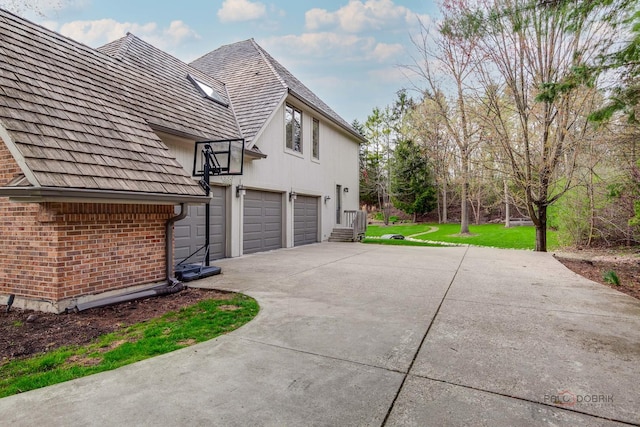 318 Camelot Ln, Libertyville, IL 60048 - view of property exterior featuring driveway, brick siding, a garage, and a lawn