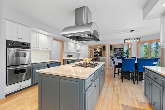 318 Camelot Ln, Libertyville, IL 60048 - kitchen featuring ventilation hood, stainless steel appliances, gray cabinetry, white cabinetry, and recessed lighting