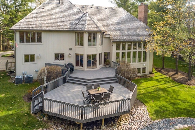 318 Camelot Ln, Libertyville, IL 60048 - rear view of property featuring a wooden deck, a chimney, outdoor dining area, and a yard