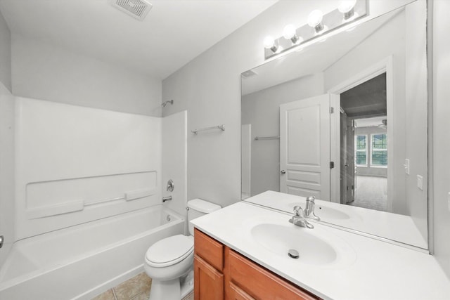 bathroom featuring toilet, washtub / shower combination, vanity, and tile patterned flooring