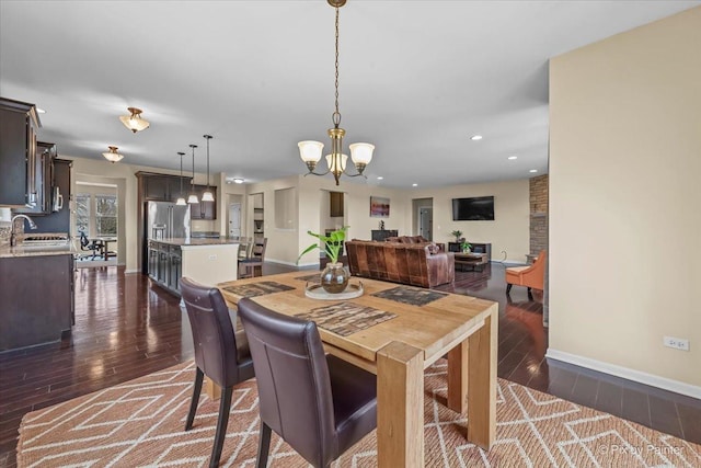 dining room featuring baseboards, recessed lighting, dark wood-style flooring, and a chandelier