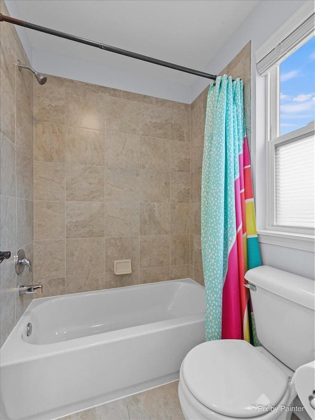 full bathroom with toilet, tile patterned flooring, and shower / bath combo with shower curtain