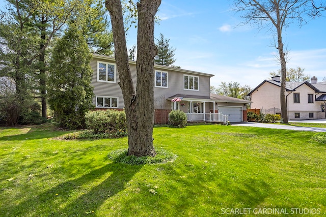 traditional-style home with an attached garage, concrete driveway, and a front yard