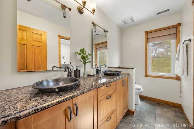 full bathroom with visible vents, plenty of natural light, and a sink