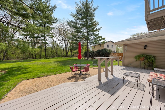 wooden deck featuring a lawn