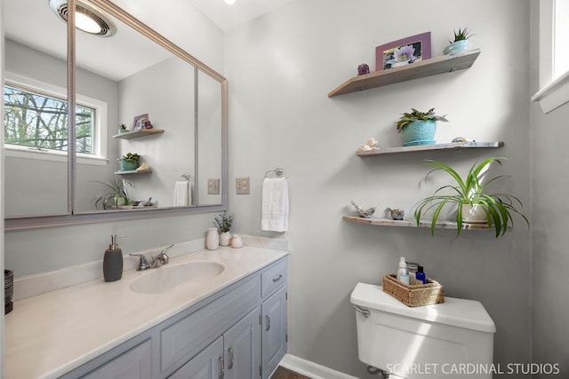 bathroom featuring toilet and vanity