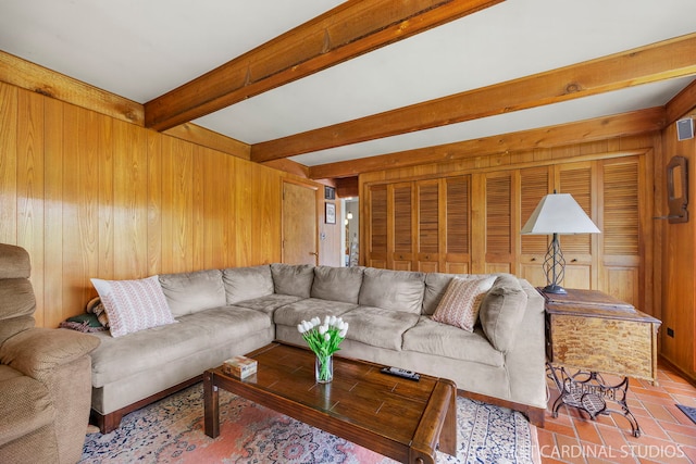 living room featuring wood walls and beam ceiling