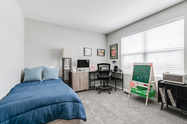 carpeted bedroom featuring baseboards