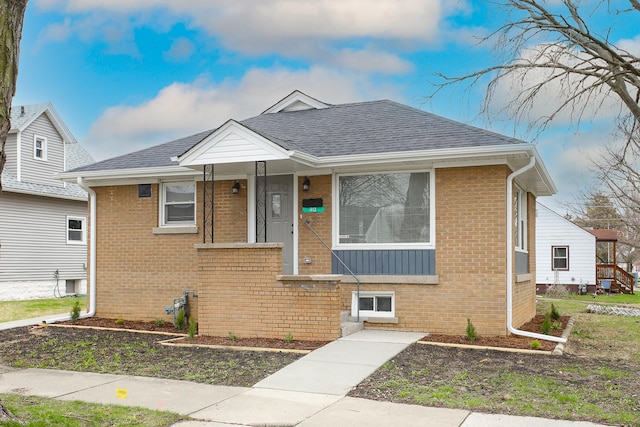 412 N Center Ave, Bradley, IL 60915 - bungalow-style house featuring roof with shingles and brick siding