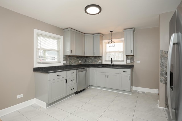 412 N Center Ave, Bradley, IL 60915 - kitchen with stainless steel appliances, baseboards, a sink, and backsplash