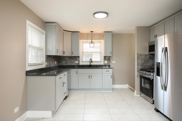 412 N Center Ave, Bradley, IL 60915 - kitchen featuring light tile patterned floors, a sink, stainless steel appliances, gray cabinetry, and backsplash