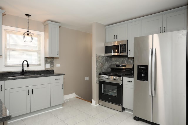 412 N Center Ave, Bradley, IL 60915 - kitchen with tasteful backsplash, dark stone countertops, decorative light fixtures, appliances with stainless steel finishes, and a sink