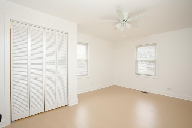412 N Center Ave, Bradley, IL 60915 - unfurnished bedroom featuring visible vents, baseboards, a closet, ceiling fan, and light wood-style floors