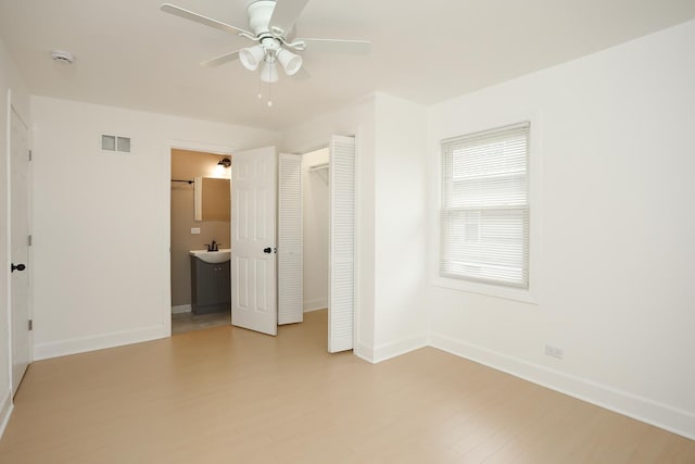 412 N Center Ave, Bradley, IL 60915 - unfurnished bedroom featuring a sink, visible vents, baseboards, and light wood-type flooring