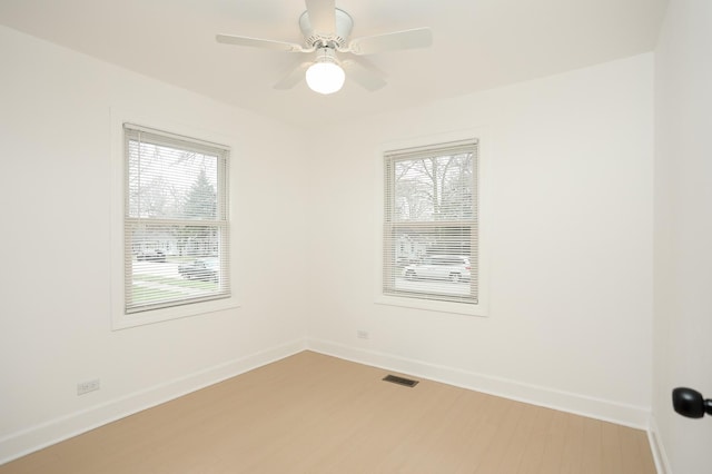 412 N Center Ave, Bradley, IL 60915 - unfurnished room with visible vents, a wealth of natural light, light wood-style floors, and baseboards