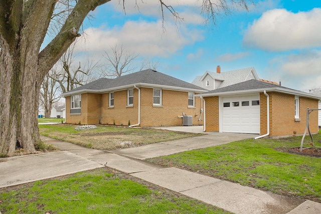 412 N Center Ave, Bradley, IL 60915 - view of home's exterior with concrete driveway, brick siding, cooling unit, and a garage