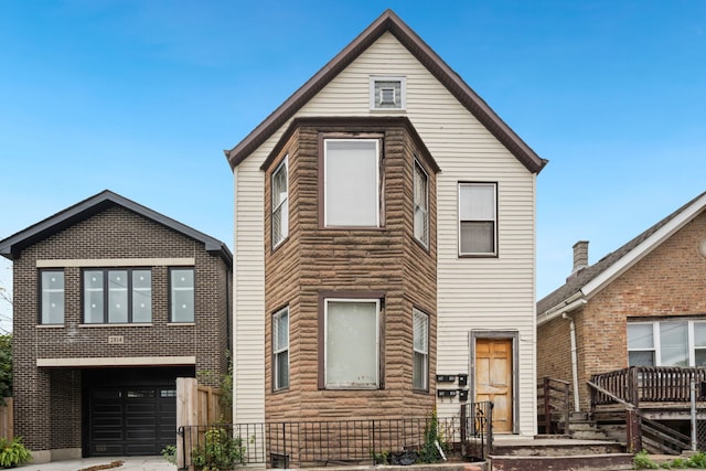 view of front facade featuring concrete driveway and an attached garage