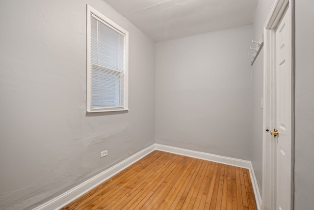 empty room with light wood-style flooring and baseboards
