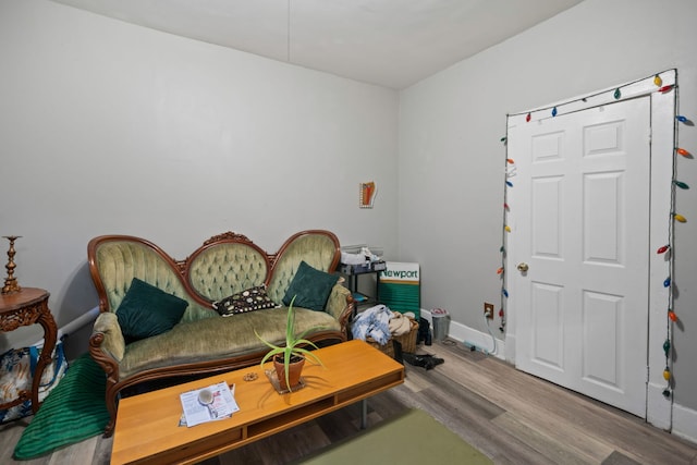 interior space with baseboards and wood finished floors