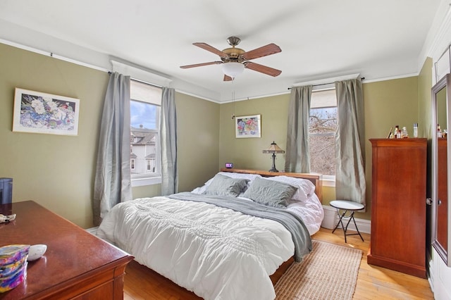 bedroom featuring light wood-style flooring and ceiling fan