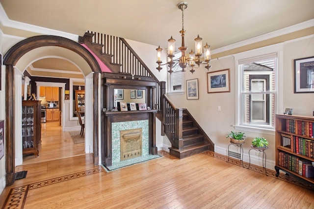 interior space featuring a chandelier, stairs, and light wood-style flooring
