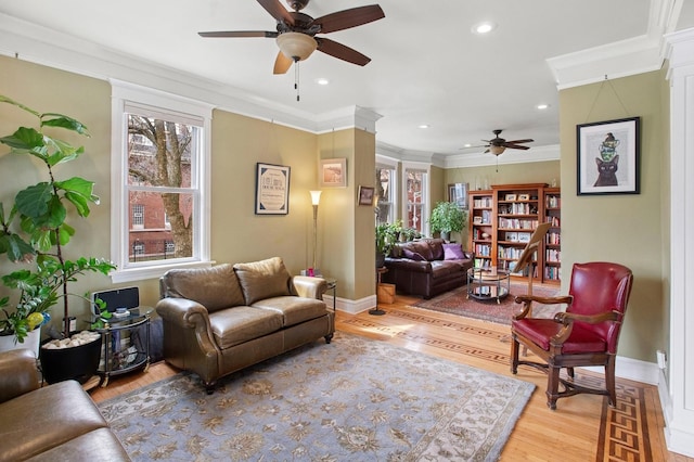 living room featuring ornamental molding, a ceiling fan, recessed lighting, light wood finished floors, and baseboards