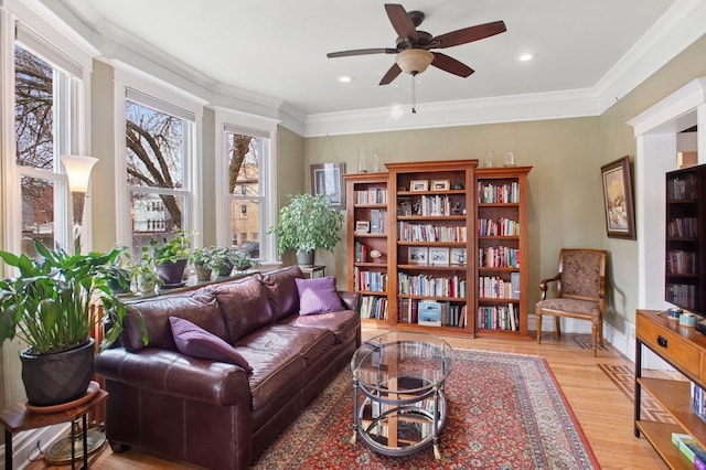 sitting room with crown molding, a ceiling fan, recessed lighting, wood finished floors, and baseboards