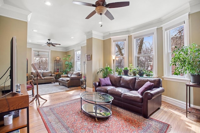 living area with light wood-type flooring, ceiling fan, ornamental molding, and recessed lighting