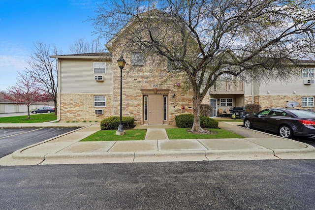 1520 W Sand Bar Ct Unit 1B, Round Lake Beach, IL 60073 - traditional-style house featuring brick siding and uncovered parking