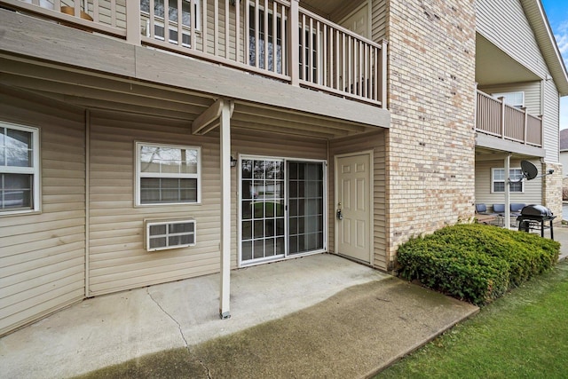 1520 W Sand Bar Ct Unit 1B, Round Lake Beach, IL 60073 - property entrance featuring a patio, a balcony, and brick siding