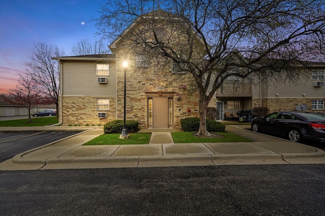 1520 W Sand Bar Ct Unit 1B, Round Lake Beach, IL 60073 - traditional-style house featuring brick siding and uncovered parking