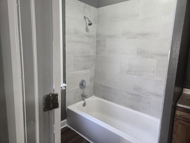 full bath featuring washtub / shower combination and wood finished floors