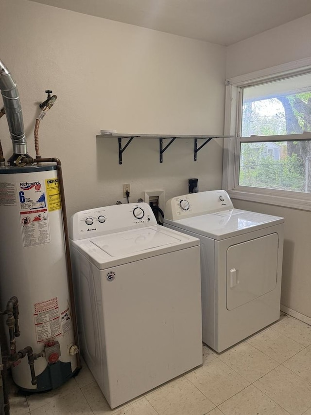 washroom with water heater, laundry area, and independent washer and dryer