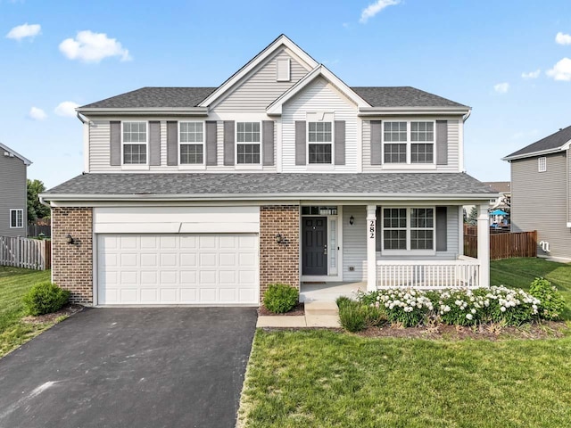 282 Willington Way, Oswego, IL 60543 - traditional-style home featuring driveway, a porch, brick siding, a garage, and roof with shingles