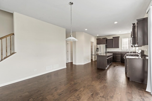 282 Willington Way, Oswego, IL 60543 - kitchen featuring stainless steel fridge, dark countertops, dark brown cabinetry, a center island, and dark wood-type flooring