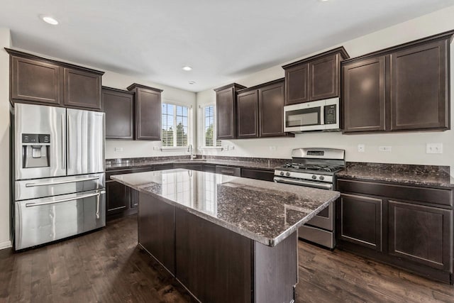 282 Willington Way, Oswego, IL 60543 - kitchen with appliances with stainless steel finishes, dark brown cabinets, dark stone countertops, dark wood finished floors, and recessed lighting