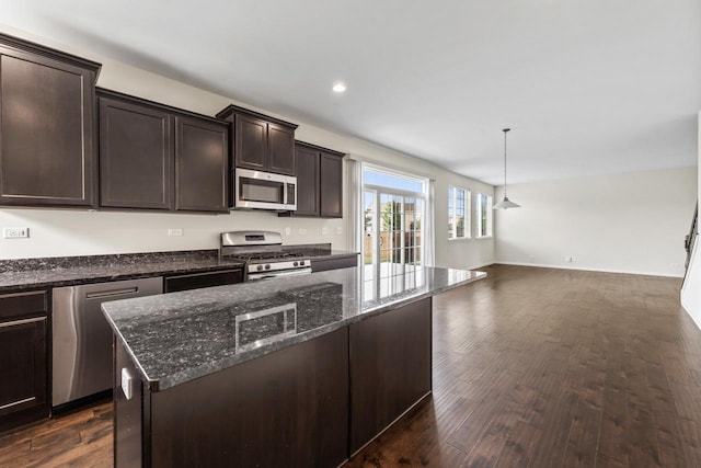 282 Willington Way, Oswego, IL 60543 - kitchen featuring appliances with stainless steel finishes, dark brown cabinets, open floor plan, dark stone counters, and dark wood-style flooring