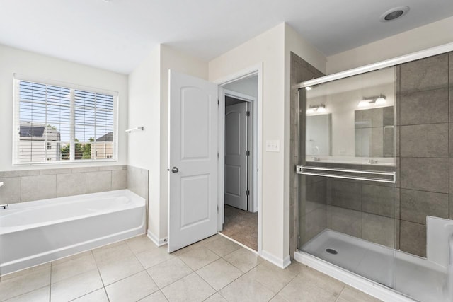 282 Willington Way, Oswego, IL 60543 - full bath featuring tile patterned flooring, a bath, a stall shower, and baseboards