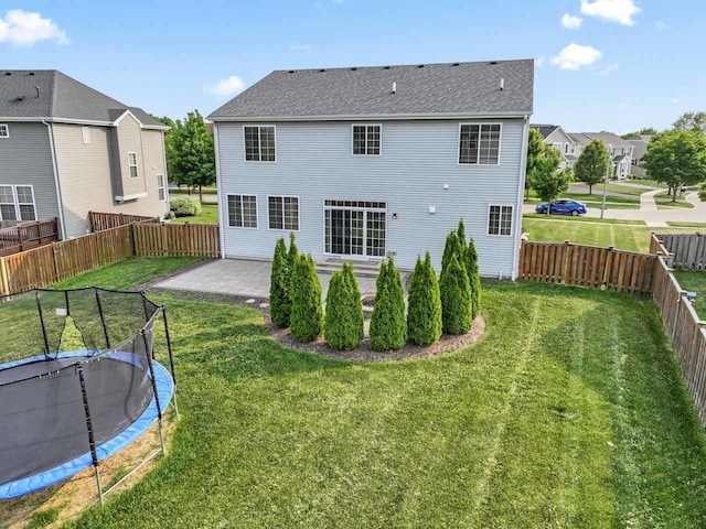 282 Willington Way, Oswego, IL 60543 - rear view of property featuring a patio, a trampoline, roof with shingles, and a residential view