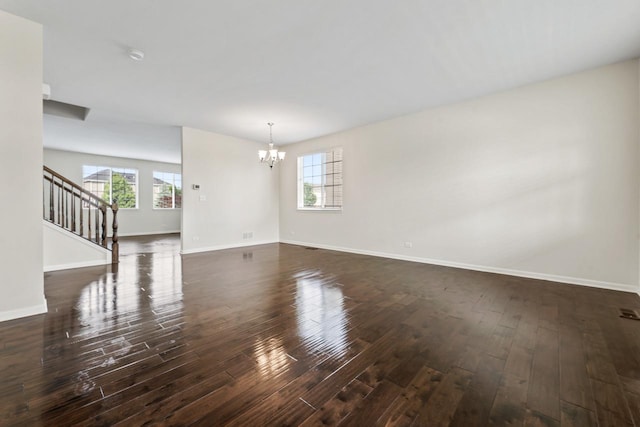 282 Willington Way, Oswego, IL 60543 - unfurnished living room featuring a chandelier, baseboards, dark wood-style floors, and stairway