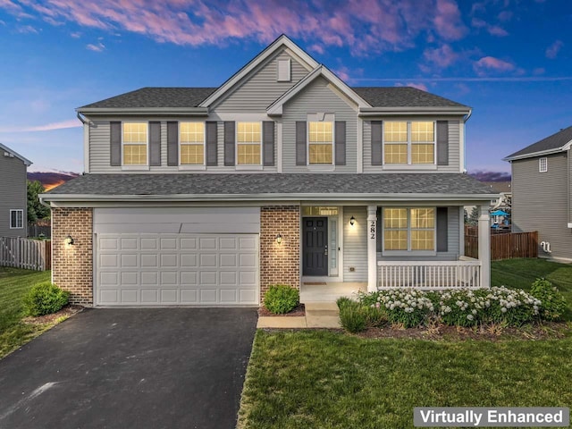 282 Willington Way, Oswego, IL 60543 - traditional home featuring covered porch, an attached garage, asphalt driveway, brick siding, and a shingled roof