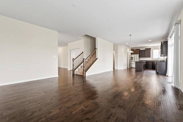 282 Willington Way, Oswego, IL 60543 - unfurnished living room with dark wood finished floors, stairway, and baseboards