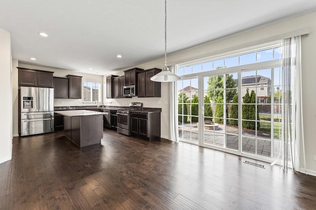 282 Willington Way, Oswego, IL 60543 - kitchen featuring appliances with stainless steel finishes, dark brown cabinets, plenty of natural light, a kitchen island, and recessed lighting