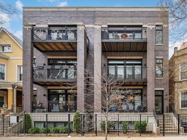 view of apartment building / complex with a fenced front yard