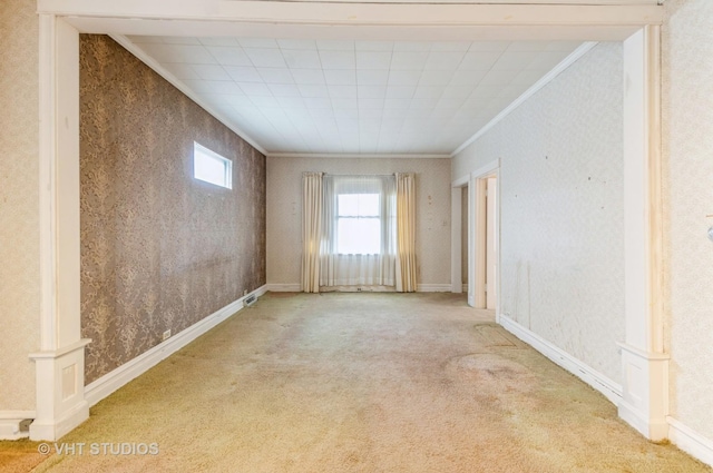 carpeted spare room featuring wallpapered walls and crown molding