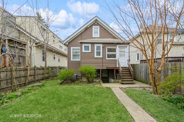 back of property featuring a fenced backyard and a yard