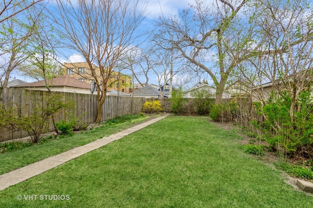 view of yard with a fenced backyard and a residential view
