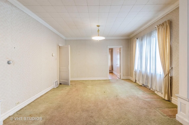 empty room featuring visible vents, crown molding, and light carpet